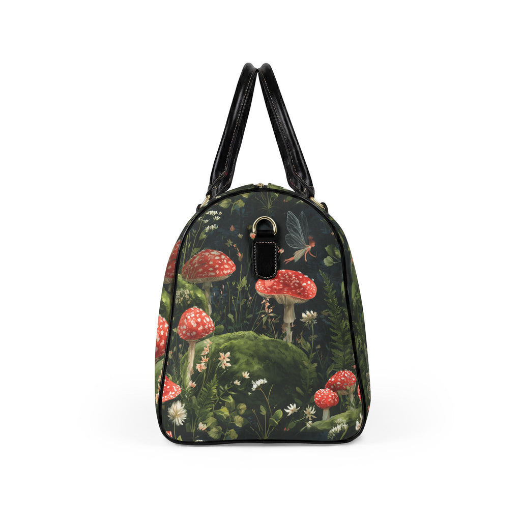 A structured black handbag featuring a detailed woodland print of red and white mushrooms, green moss, and a small fairy, with black leather handles and trim.