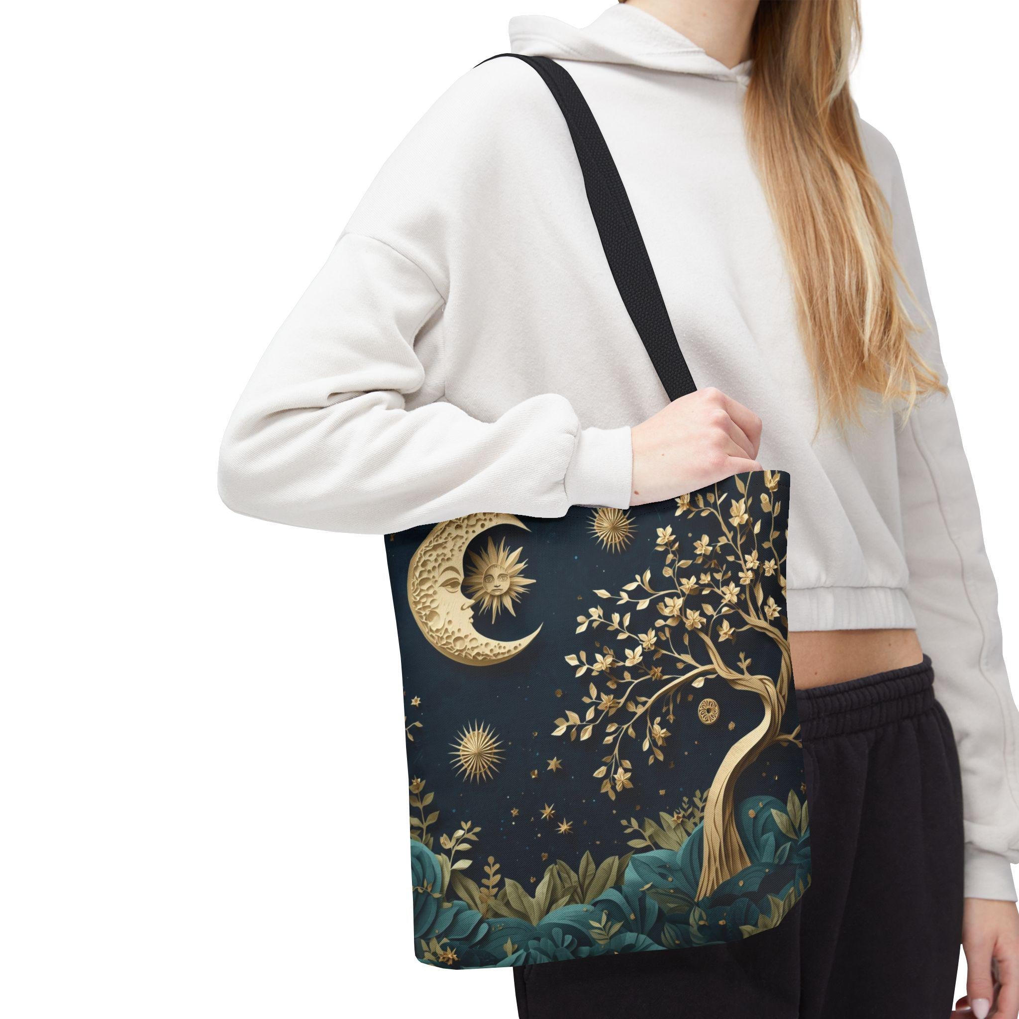 Woman holding Celestial Moon Tree of Life Tote Bag with gold moon and stars design on navy canvas