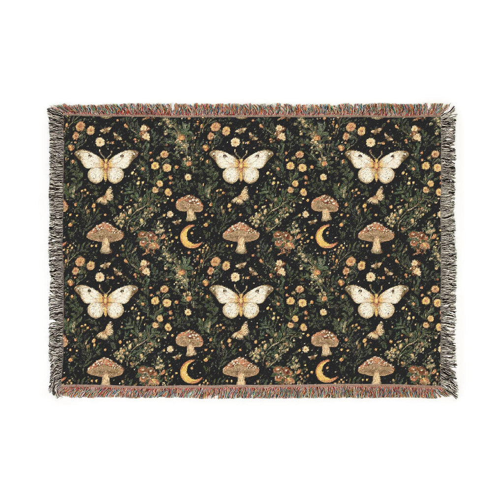 A rectangular woven throw blanket with fringe edges, featuring a dark forest pattern with white butterflies, brown mushrooms, and small yellow flowers.
