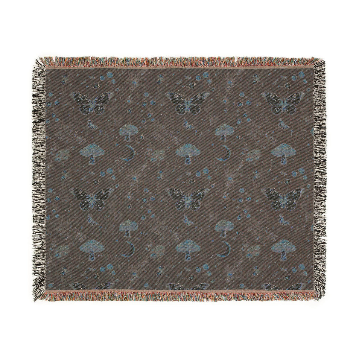 A square woven throw blanket with fringe edges, featuring a dark brown background patterned with butterflies, mushrooms, and small blue celestial motifs.
