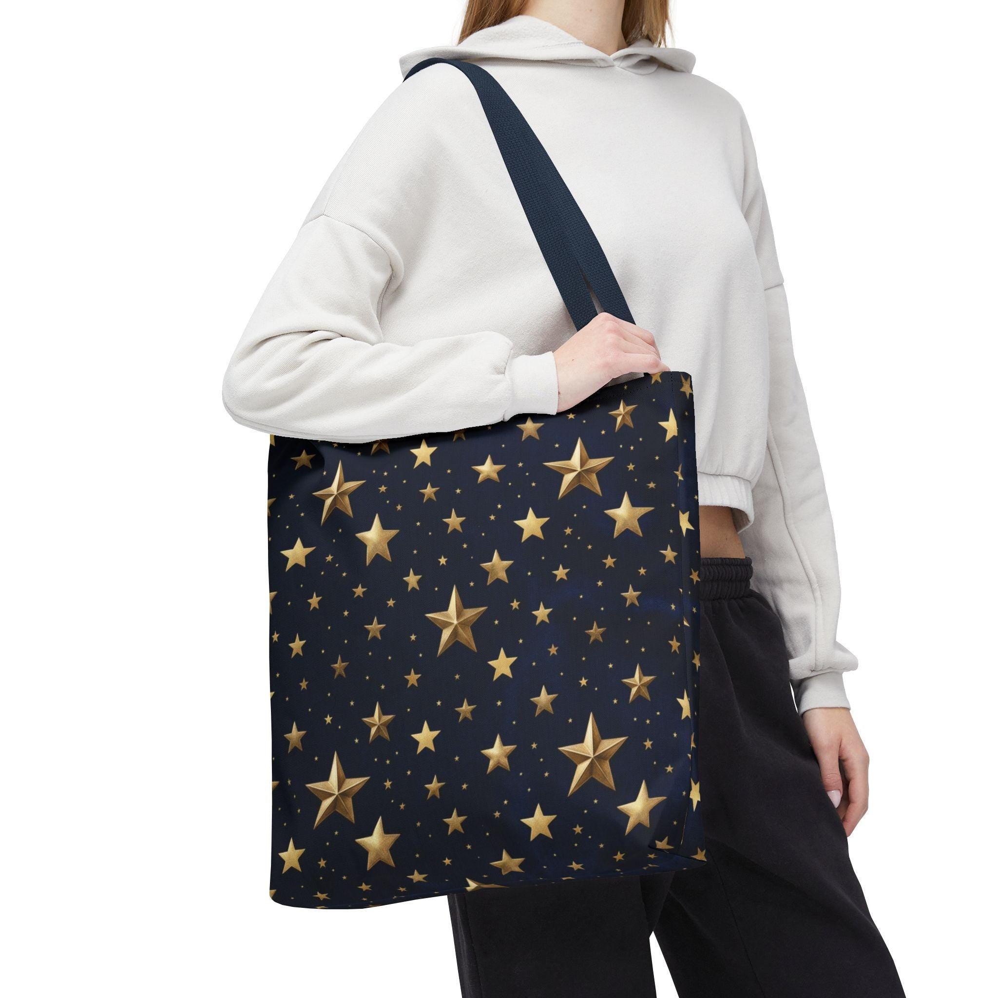 Gold star pattern tote bag over shoulder — navy night sky all-over print tote worn as shoulder bag