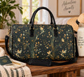 Enchanted forest fairy duffel bag in dark green with gold leaves, twisting trees, and tiny fairies, styled with a shoulder strap, sun hat, passport, and journal