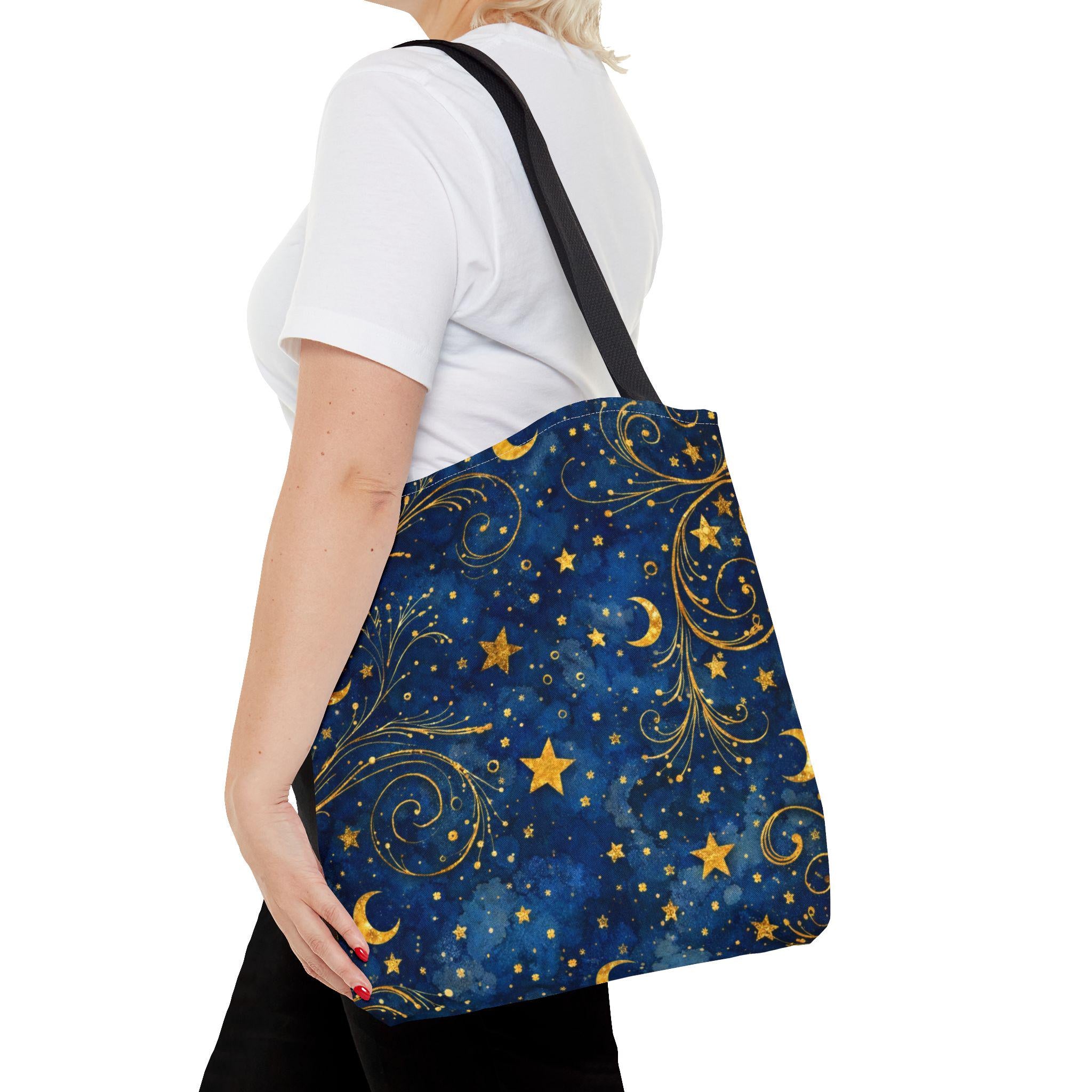 Woman carrying Celestial Navy Blue Tote Bag with gold moon and stars pattern — boho night sky canvas tote
