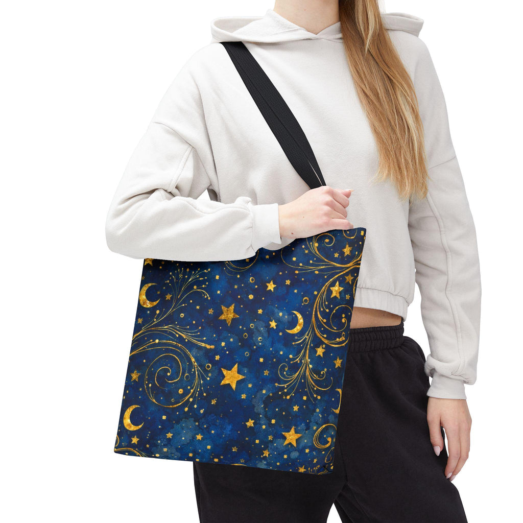Woman in hoodie carrying Celestial Navy Blue Tote Bag — gold crescent moons and stars swirl pattern on canvas