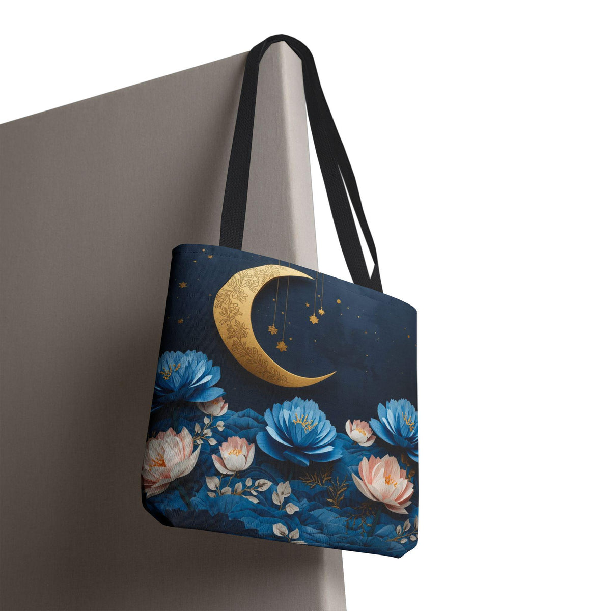 Tote bag with floral and moon design on a plain background