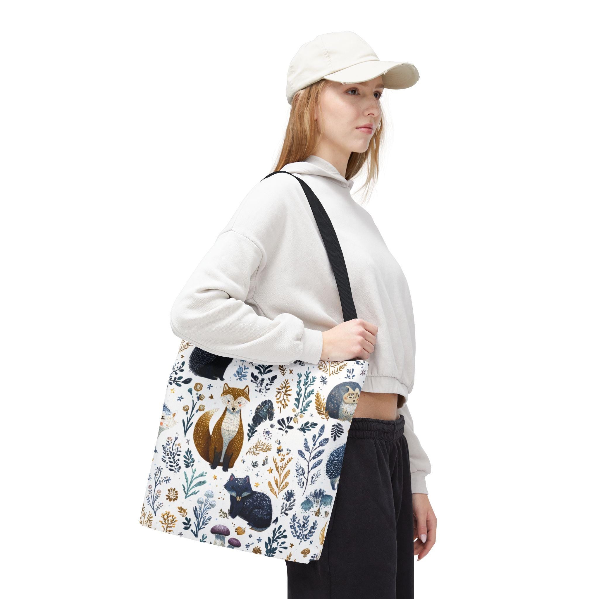 Woman wearing Woodland Fox and Hedgehog Tote Bag — forest animal print with foxes, hedgehogs, and floral sprigs in navy, amber, and gray, navy strap, crossbody styling