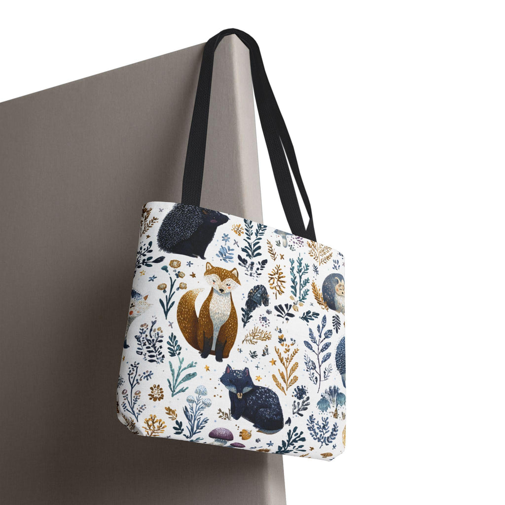 Woodland Fox and Hedgehog Tote Bag hanging — forest animal print with foxes, hedgehogs, and floral sprigs in navy, amber, and gray, navy handle