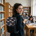 Woman wearing a crescent moon celestial backpack in a library setting
