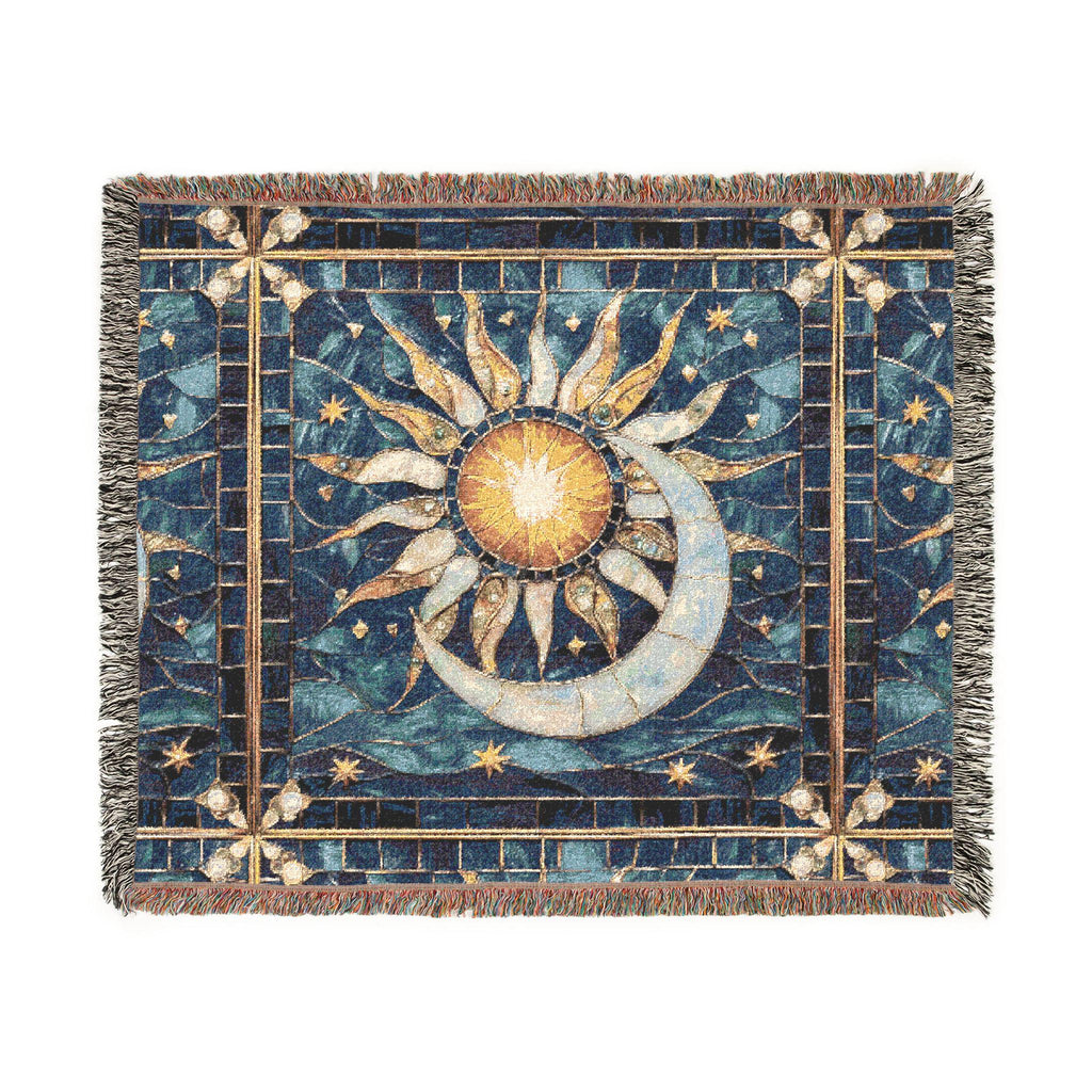A square woven throw blanket with fringe edges, featuring a celestial design of a sun, crescent moon, and stars in shades of blue, gold, and beige on a white background.