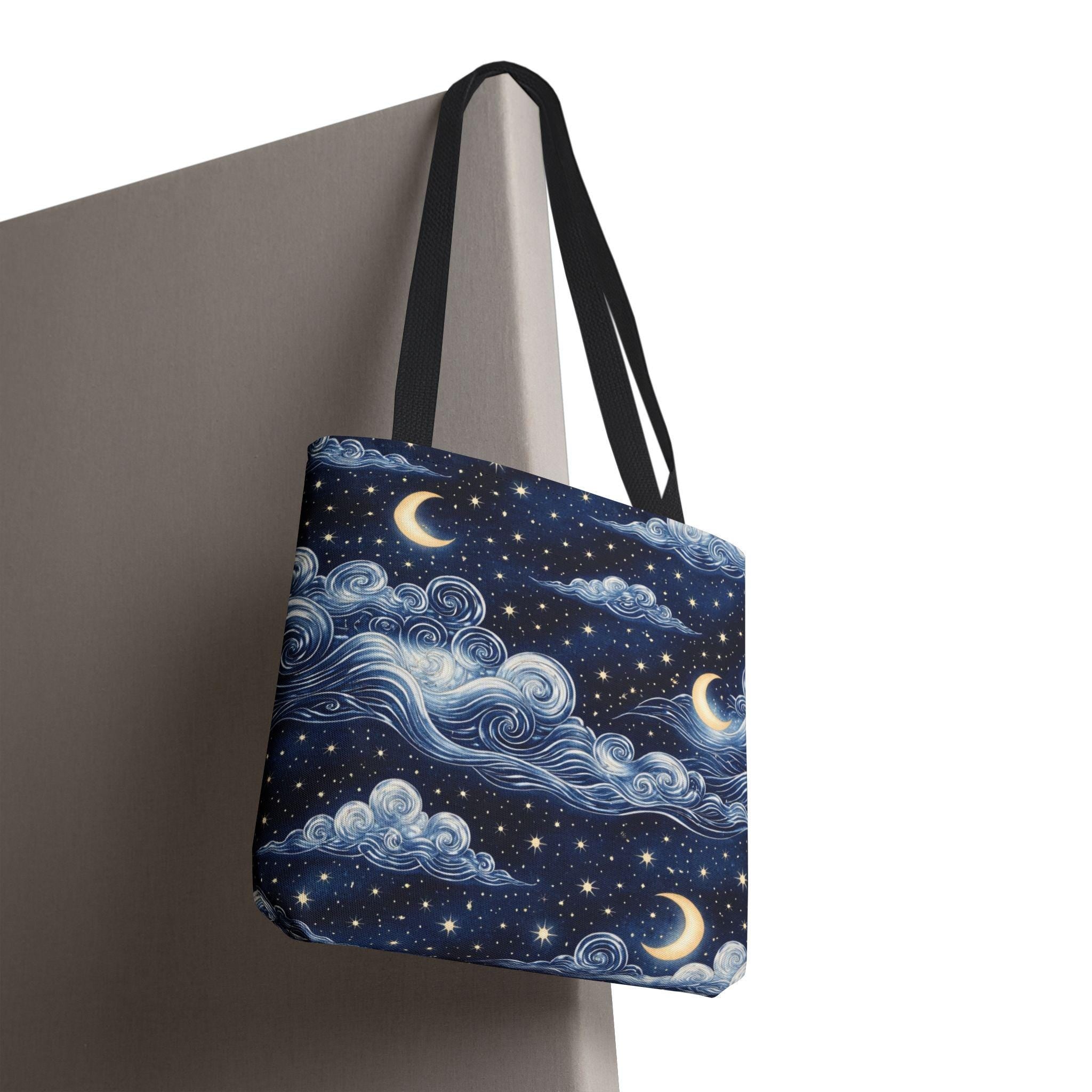 Moon and whimsical clouds tote bag hanging on wall — second angle showing navy night sky swirling clouds and crescent moon print