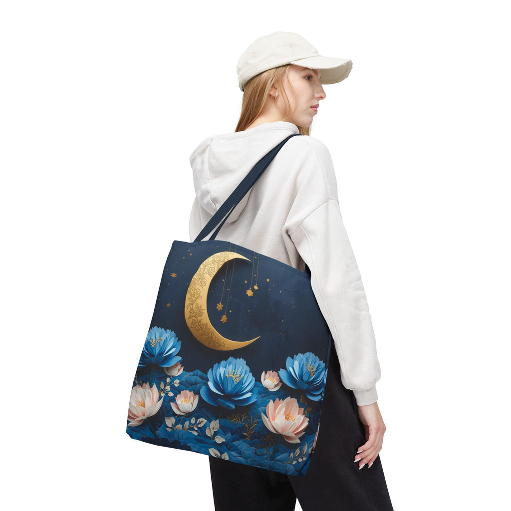 Person wearing a white hoodie and beige cap, carrying a tote bag with floral and moon design.