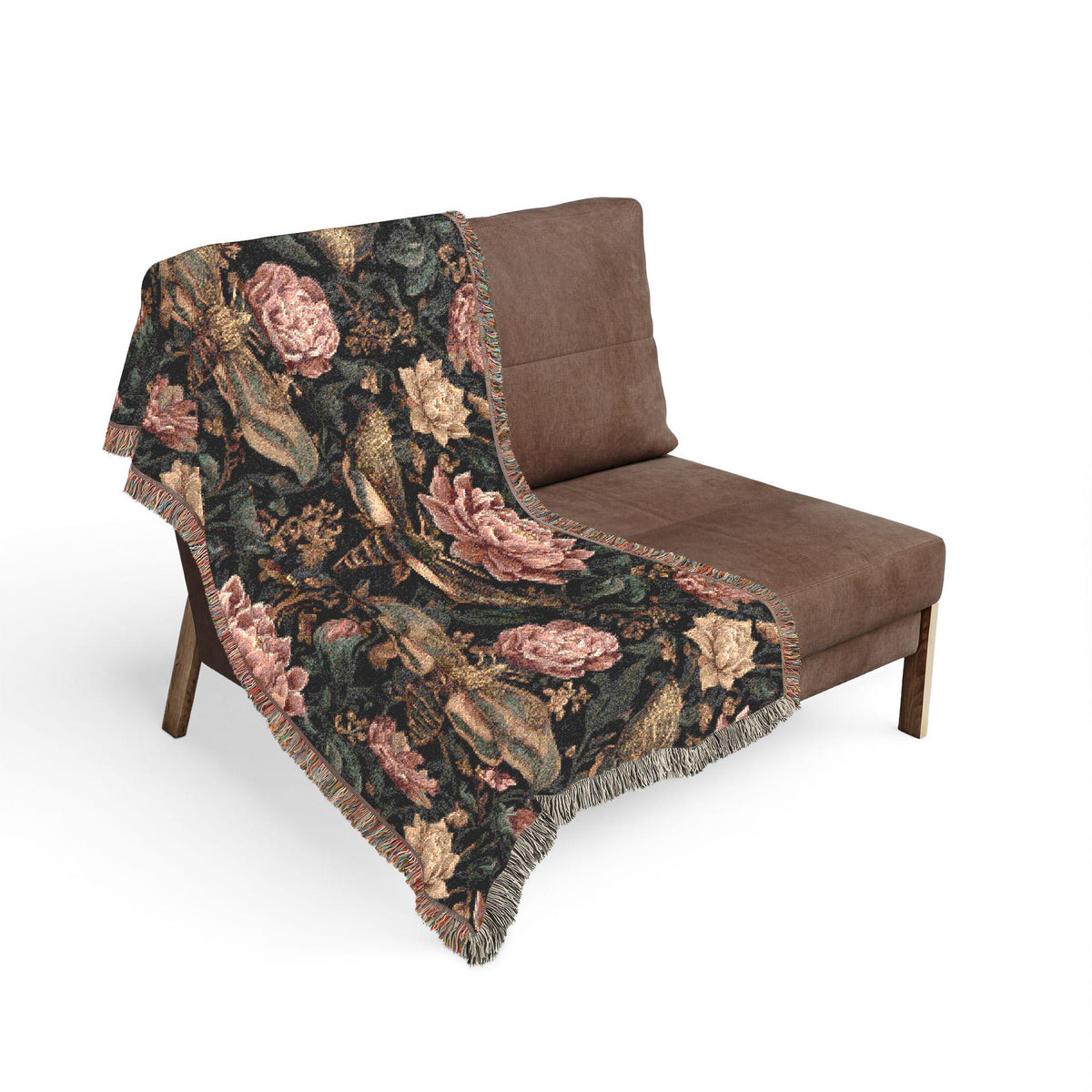 Dark vintage botanical woven throw blanket with moths, pink roses, and golden floral details draped over a brown lounge chair.