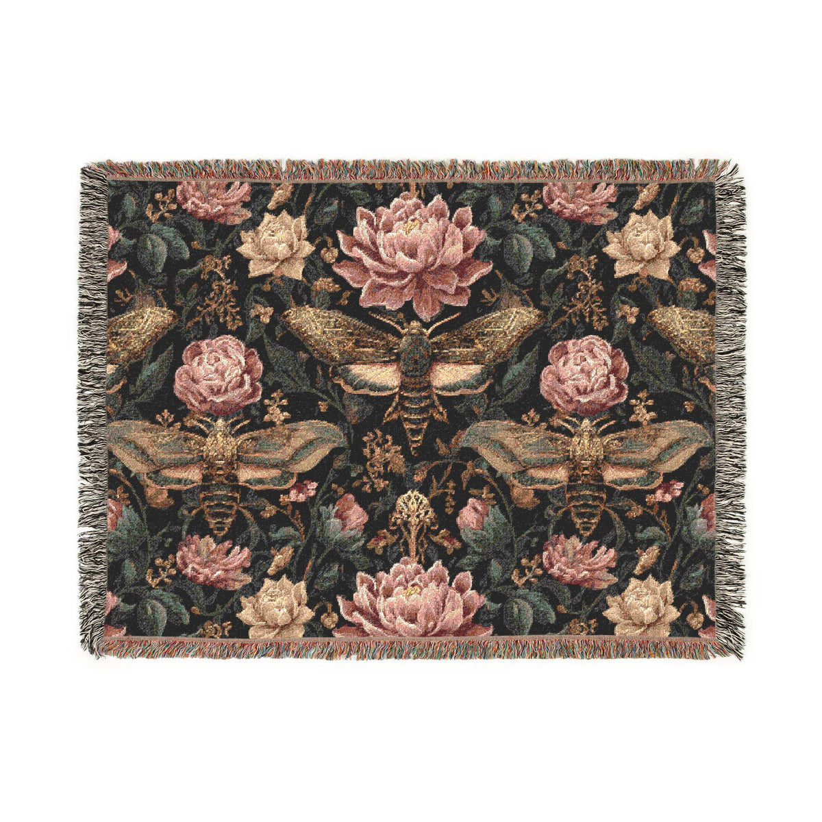 A rectangular woven throw blanket with fringe on all sides, featuring a detailed tapestry-style pattern of pink and cream flowers, moths, and bees on a dark background.